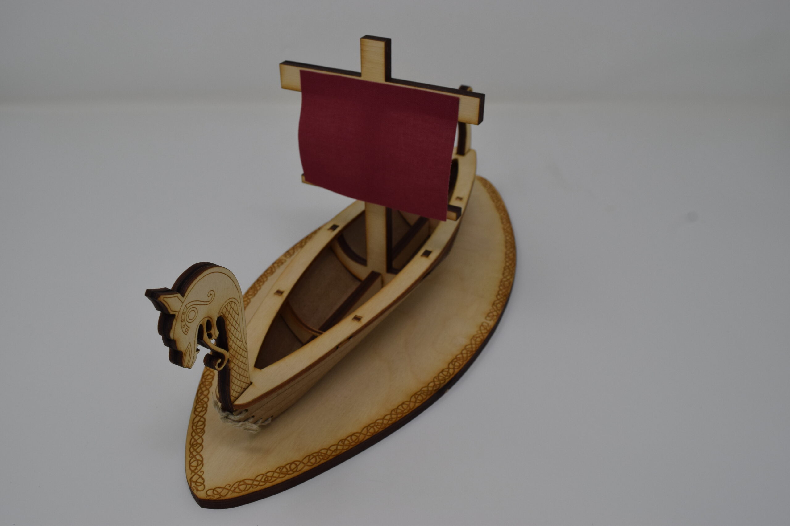 Photo of a lasercut sculpture of a viking longboat, taken slightly from above.