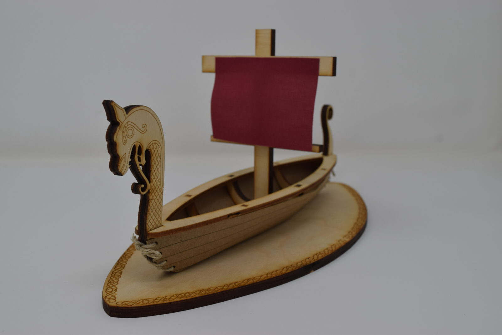 Photo of a lasercut sculpture of a viking longboat, 45-ish degree angle.