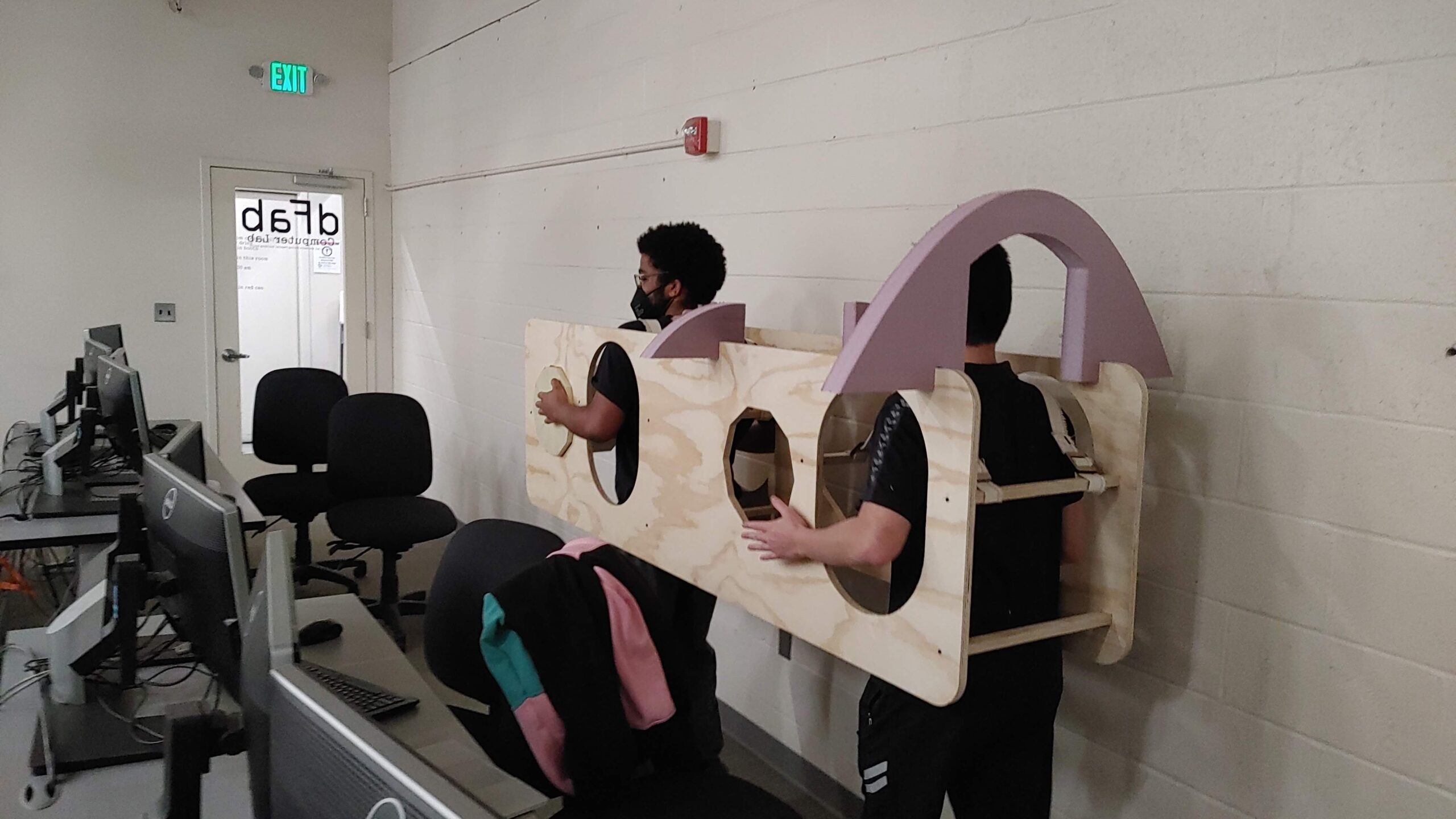 Image of two of my classmates, Asa and Austin, piloting an early chassis prototype around the dFab computer lab :)